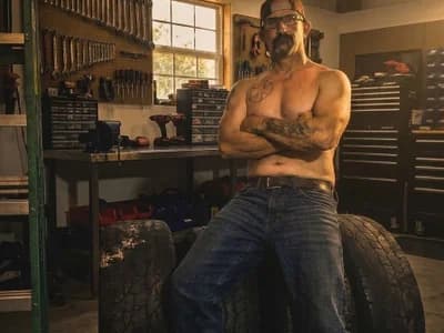 Guy Scooterrooterofficial twirls his mustache, teasing viewers in his private adult cam room